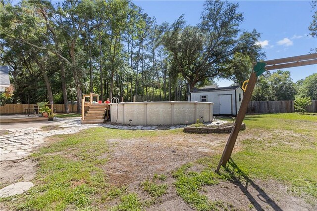 67 Oak Side Ct, Richmond Hill, GA 31324 - view of yard featuring a wooden deck and an outdoor pool