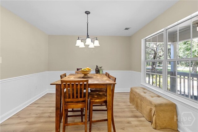 67 Oak Side Ct, Richmond Hill, GA 31324 - dining room featuring a chandelier, light wood finished floors, and baseboards