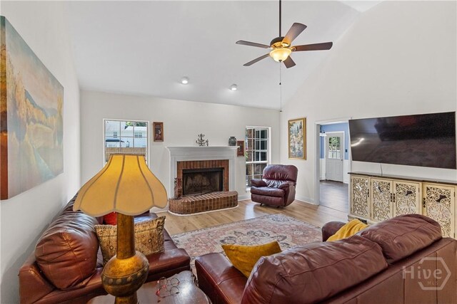 67 Oak Side Ct, Richmond Hill, GA 31324 - living area with wood finished floors, a ceiling fan, high vaulted ceiling, a brick fireplace, and recessed lighting