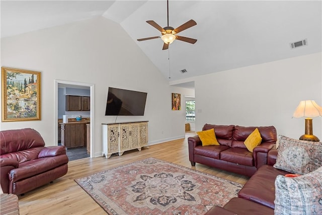 67 Oak Side Ct, Richmond Hill, GA 31324 - living area featuring a ceiling fan, high vaulted ceiling, light wood finished floors, and baseboards