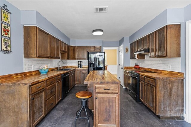 67 Oak Side Ct, Richmond Hill, GA 31324 - kitchen with wood counters, black appliances, a sink, under cabinet range hood, and backsplash