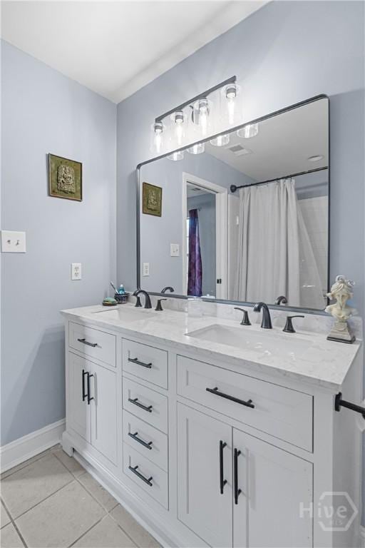 67 Oak Side Ct, Richmond Hill, GA 31324 - bathroom with double vanity, tile patterned flooring, and baseboards