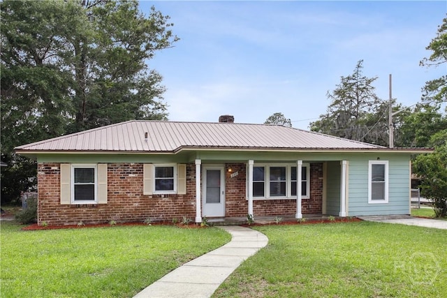 2301 Pinetree Rd, Savannah, GA 31404 - view of front of property featuring a front yard, metal roof, covered porch, and brick siding
