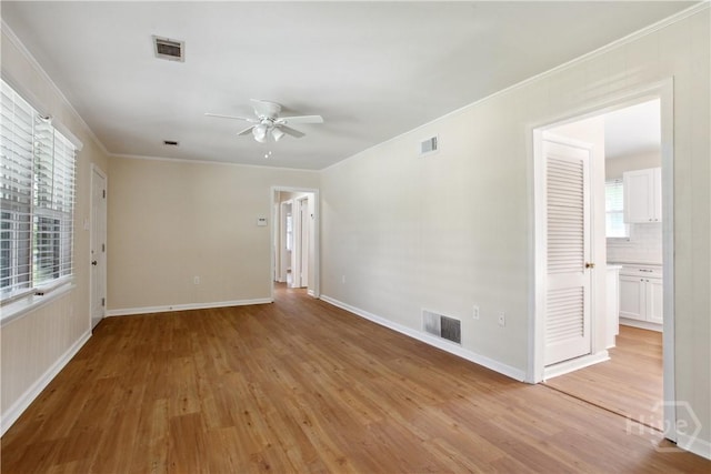 2301 Pinetree Rd, Savannah, GA 31404 - empty room with ceiling fan, light wood-type flooring, baseboards, and crown molding