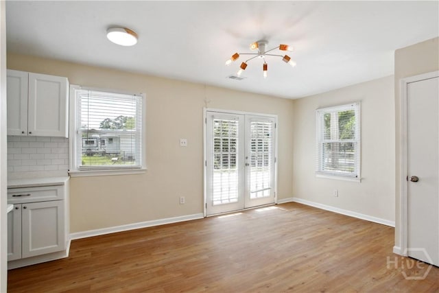 2301 Pinetree Rd, Savannah, GA 31404 - unfurnished dining area with french doors, light wood-style floors, and baseboards