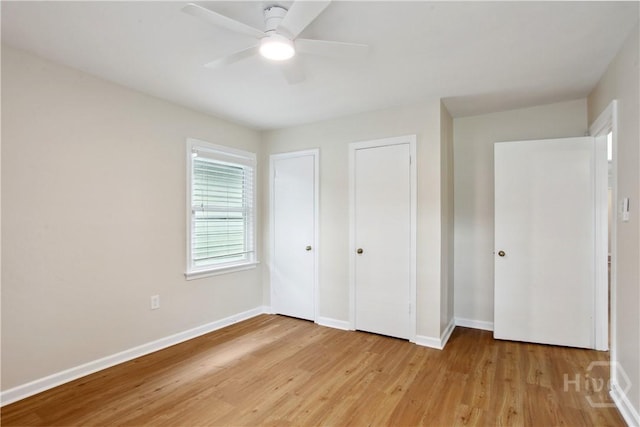 2301 Pinetree Rd, Savannah, GA 31404 - unfurnished bedroom featuring light wood-style flooring, baseboards, two closets, and a ceiling fan