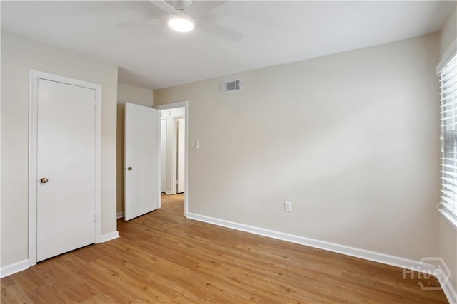 2301 Pinetree Rd, Savannah, GA 31404 - unfurnished bedroom featuring baseboards, light wood-style floors, multiple windows, and a ceiling fan