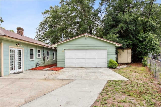 2301 Pinetree Rd, Savannah, GA 31404 - view of front of home featuring a garage, an outbuilding, driveway, and a chimney