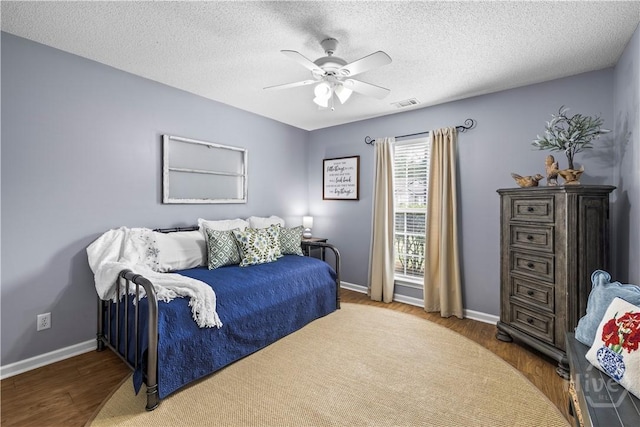 267 Jasper Ln, Rincon, GA 31326 - bedroom with wood finished floors, baseboards, ceiling fan, and a textured ceiling