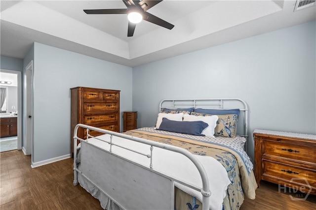 267 Jasper Ln, Rincon, GA 31326 - bedroom featuring wood finished floors, baseboards, a raised ceiling, ceiling fan, and ensuite bathroom