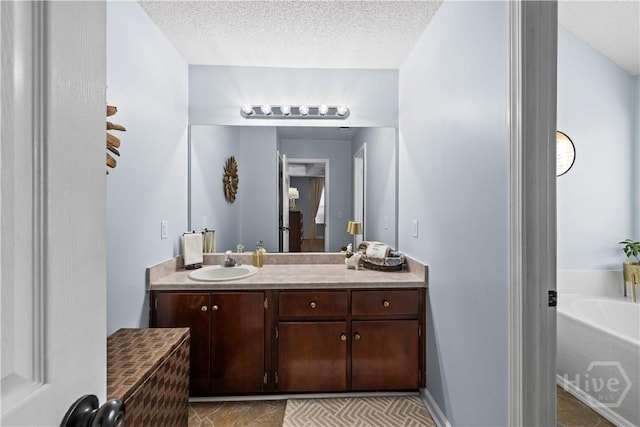 267 Jasper Ln, Rincon, GA 31326 - full bathroom featuring vanity, a garden tub, and a textured ceiling