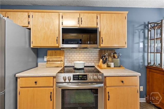 267 Jasper Ln, Rincon, GA 31326 - kitchen featuring appliances with stainless steel finishes, light countertops, backsplash, light brown cabinets, and tile patterned flooring