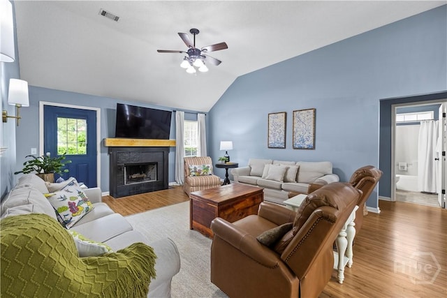 267 Jasper Ln, Rincon, GA 31326 - living room featuring vaulted ceiling, a ceiling fan, wood finished floors, a fireplace, and baseboards