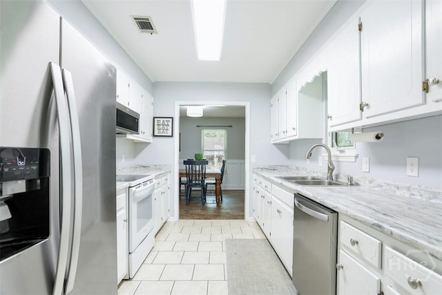 15 Ramble Rd, Statesboro, GA 30458 - kitchen featuring appliances with stainless steel finishes, a sink, white cabinetry, and light tile patterned flooring