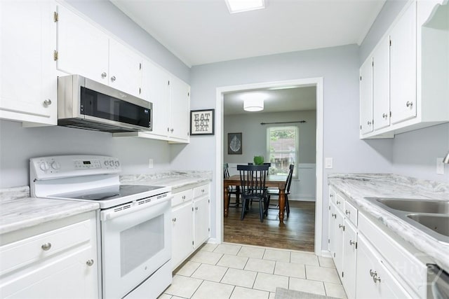 15 Ramble Rd, Statesboro, GA 30458 - kitchen with stainless steel appliances, a sink, white cabinets, light countertops, and light tile patterned flooring