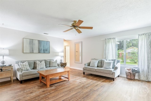 15 Ramble Rd, Statesboro, GA 30458 - living area with wood finished floors, ceiling fan, baseboards, and a textured ceiling