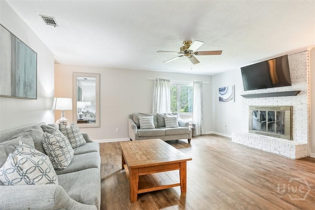 15 Ramble Rd, Statesboro, GA 30458 - living area with wood finished floors, a ceiling fan, a brick fireplace, and baseboards