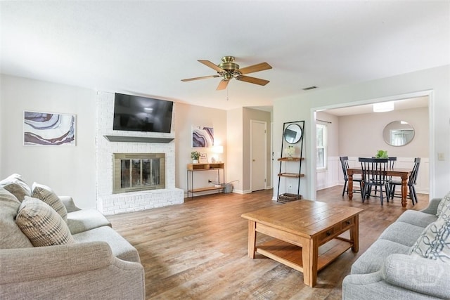 15 Ramble Rd, Statesboro, GA 30458 - living room with a ceiling fan, wood finished floors, and a brick fireplace