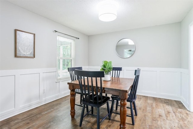 15 Ramble Rd, Statesboro, GA 30458 - dining space with a decorative wall, wood finished floors, and wainscoting