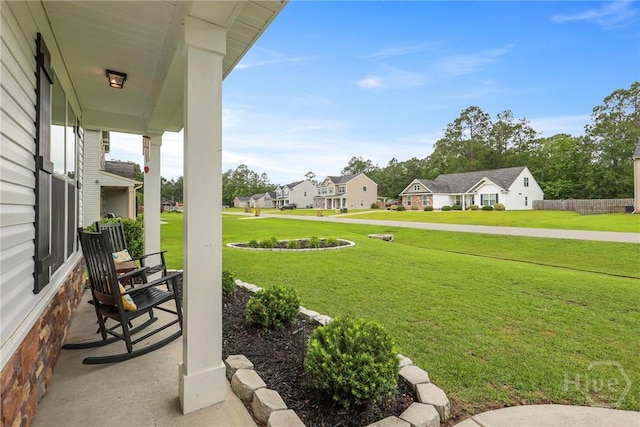 108 Summer Station Dr, Guyton, GA 31312 - view of green lawn featuring a residential view and a porch