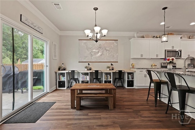 108 Summer Station Dr, Guyton, GA 31312 - dining space featuring a chandelier, dark wood finished floors, crown molding, recessed lighting, and a desk