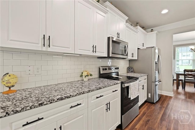 108 Summer Station Dr, Guyton, GA 31312 - kitchen featuring stainless steel appliances, ornamental molding, white cabinets, dark wood finished floors, and light stone counters