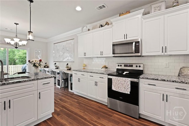 108 Summer Station Dr, Guyton, GA 31312 - kitchen with stainless steel appliances, a sink, ornamental molding, stone counters, and white cabinets