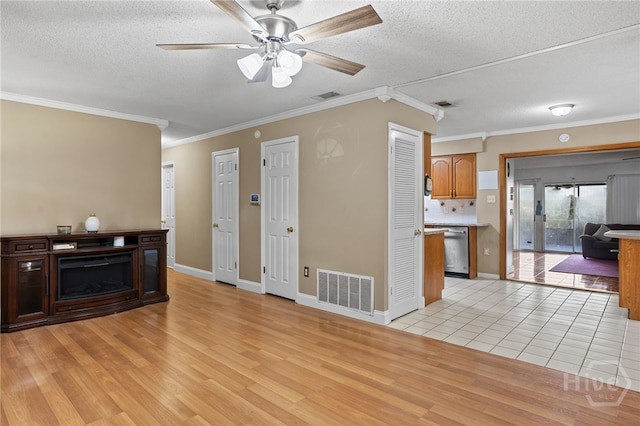 114 Piercefield Dr, Richmond Hill, GA 31324 - unfurnished living room featuring crown molding, a textured ceiling, light wood finished floors, and a ceiling fan