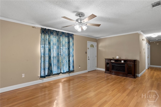 114 Piercefield Dr, Richmond Hill, GA 31324 - unfurnished living room with crown molding, ceiling fan, a textured ceiling, and light wood-style floors