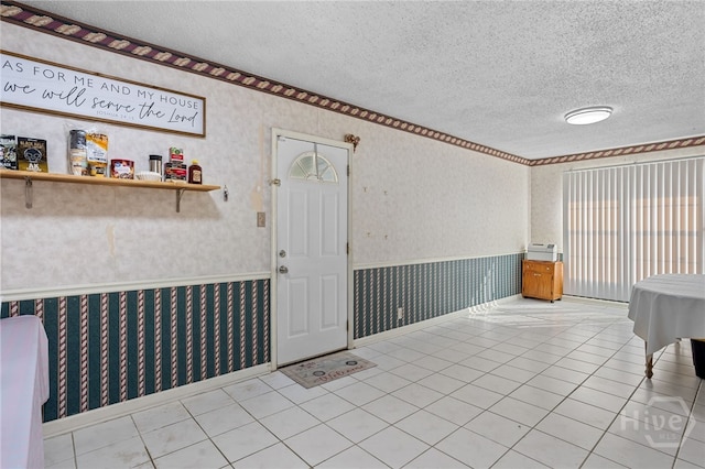 114 Piercefield Dr, Richmond Hill, GA 31324 - tiled dining room with wallpapered walls, a textured ceiling, and a wainscoted wall