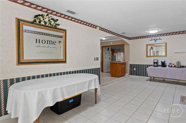 114 Piercefield Dr, Richmond Hill, GA 31324 - bathroom with wallpapered walls, a wainscoted wall, a textured ceiling, and tile patterned flooring