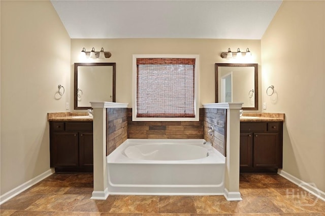 93 Veranda Trl, Midway, GA 31320 - bathroom with a bath, baseboards, and two vanities
