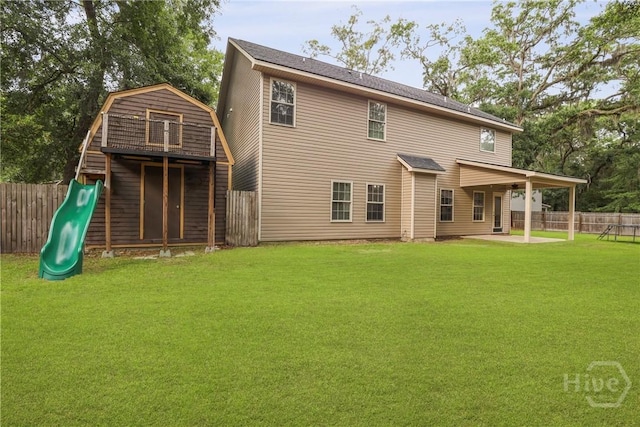 93 Veranda Trl, Midway, GA 31320 - rear view of house with a playground, a patio, and a gambrel roof