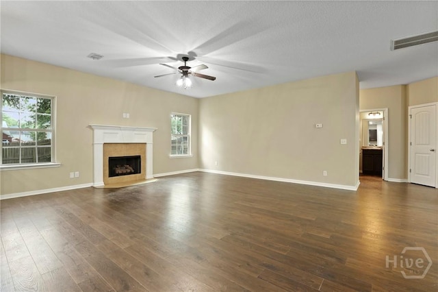 93 Veranda Trl, Midway, GA 31320 - unfurnished living room featuring a ceiling fan, plenty of natural light, dark wood-style flooring, and a high end fireplace