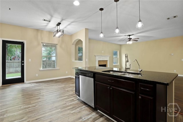 93 Veranda Trl, Midway, GA 31320 - kitchen with dishwasher, a sink, open floor plan, light wood-style floors, and a fireplace