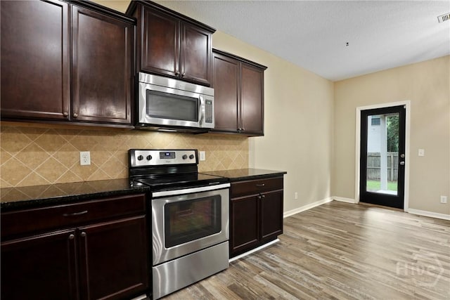93 Veranda Trl, Midway, GA 31320 - kitchen with appliances with stainless steel finishes, light wood-style floors, decorative backsplash, and baseboards