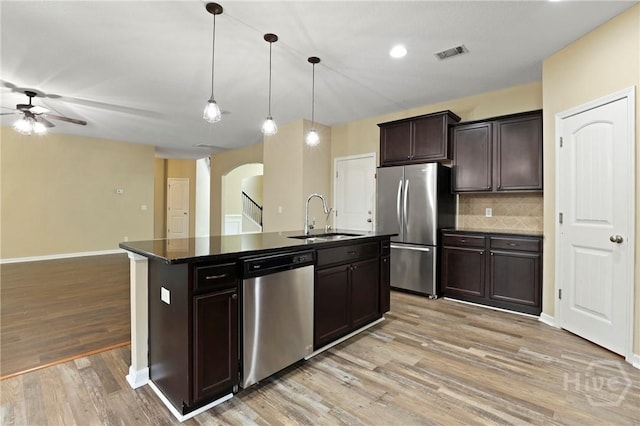 93 Veranda Trl, Midway, GA 31320 - kitchen featuring appliances with stainless steel finishes, a sink, arched walkways, ceiling fan, and light wood finished floors