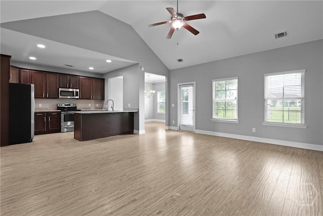 7 Sailmaker Ln, Richmond Hill, GA 31324 - kitchen with stainless steel appliances, open floor plan, dark brown cabinetry, light wood-type flooring, and a ceiling fan