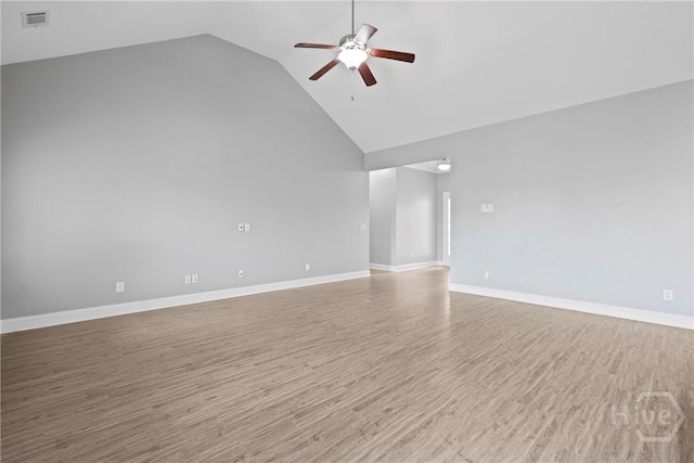 7 Sailmaker Ln, Richmond Hill, GA 31324 - empty room featuring a ceiling fan, wood finished floors, high vaulted ceiling, and baseboards