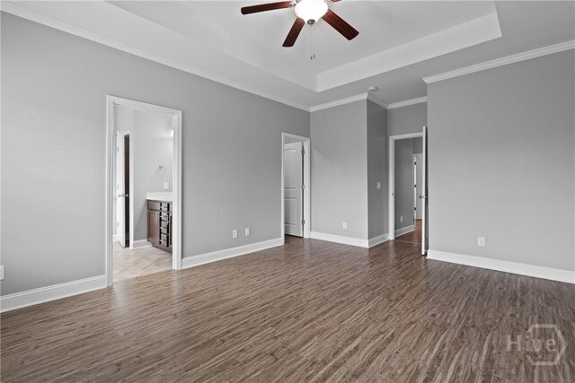 7 Sailmaker Ln, Richmond Hill, GA 31324 - unfurnished room with a tray ceiling, ceiling fan, wood finished floors, baseboards, and ornamental molding