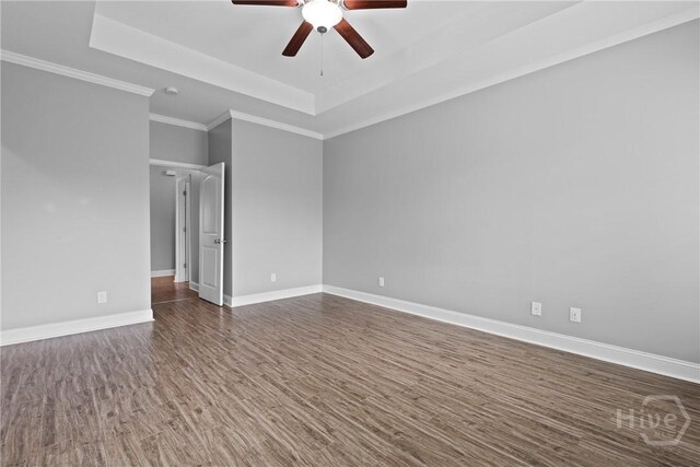 7 Sailmaker Ln, Richmond Hill, GA 31324 - spare room featuring a raised ceiling, a ceiling fan, dark wood-style floors, baseboards, and crown molding