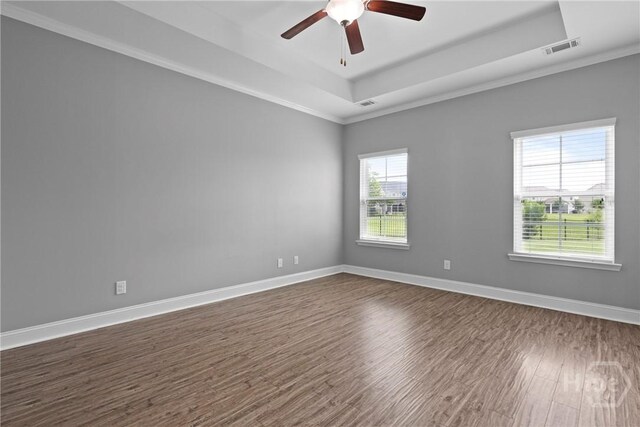 7 Sailmaker Ln, Richmond Hill, GA 31324 - empty room featuring a tray ceiling, dark wood finished floors, crown molding, ceiling fan, and baseboards