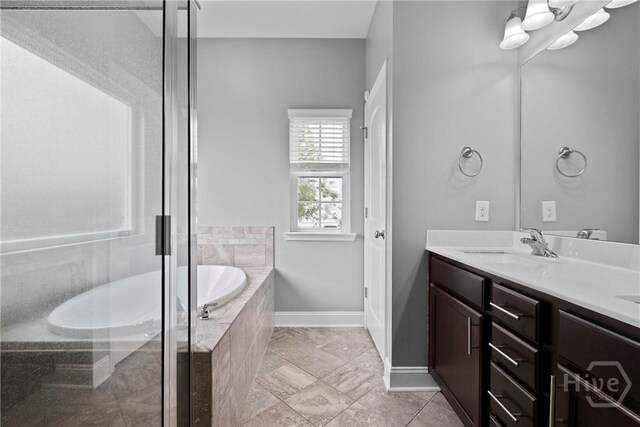 7 Sailmaker Ln, Richmond Hill, GA 31324 - bathroom with a bath, double vanity, baseboards, and a stall shower