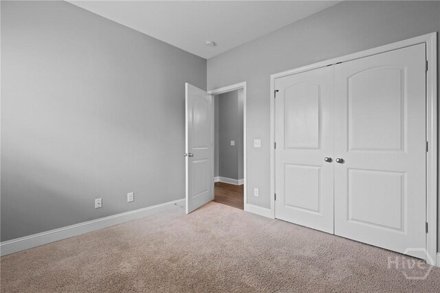 7 Sailmaker Ln, Richmond Hill, GA 31324 - unfurnished bedroom featuring carpet floors, baseboards, and a closet