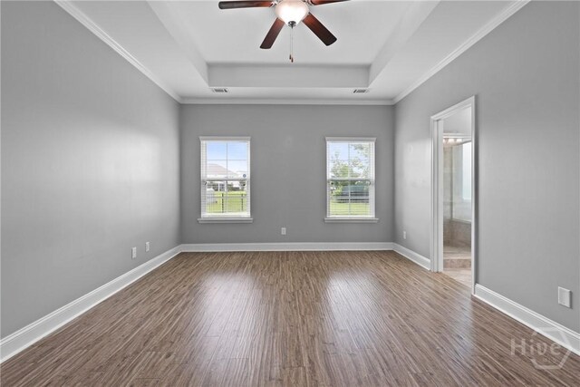 7 Sailmaker Ln, Richmond Hill, GA 31324 - spare room featuring a raised ceiling, wood finished floors, a ceiling fan, baseboards, and ornamental molding