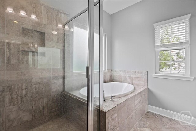 7 Sailmaker Ln, Richmond Hill, GA 31324 - bathroom featuring a bath, a stall shower, and baseboards