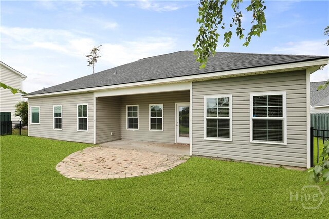 7 Sailmaker Ln, Richmond Hill, GA 31324 - rear view of house with a patio and roof with shingles
