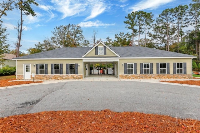 7 Sailmaker Ln, Richmond Hill, GA 31324 - view of building exterior with a carport and driveway