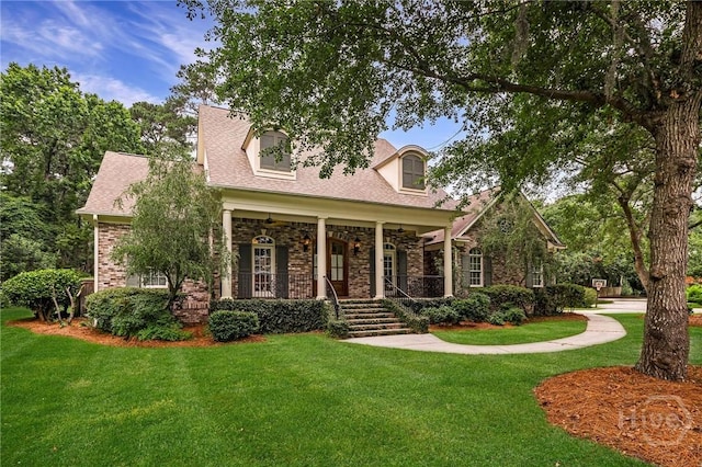 10 Cedar View Dr, Savannah, GA 31410 - cape cod home featuring a front yard, covered porch, brick siding, and roof with shingles