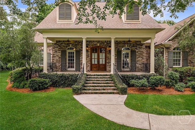 10 Cedar View Dr, Savannah, GA 31410 - view of exterior entry featuring covered porch, a lawn, french doors, and roof with shingles